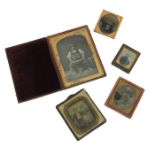 A collection of daguerreotype or ambrotype photographs