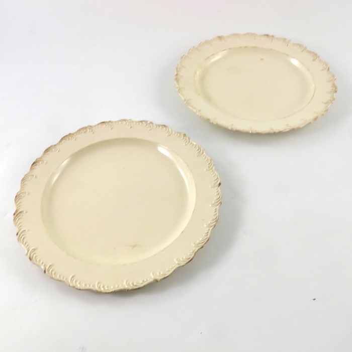 An English creamware charger and two plates, circa 1780