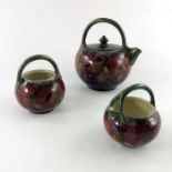 William Moorcroft, a pomegranate on ochre three piece tea set, circa 1914,