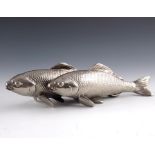 A Japanese white metal or plated okimono figure group of two carp