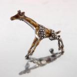 A silver marcasite and enamelled brooch, in the form of a giraffe