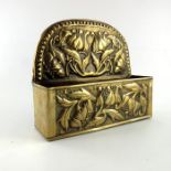 An Arts and Crafts repousse brass wall pocket, in the Keswick style