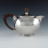 An Arts and Crafts silver teapot, AHJ, Birmingham 1945