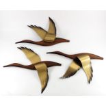 Masketeers Inc., a set of three Mid 20th Century oak and brass flying geese wall decorations