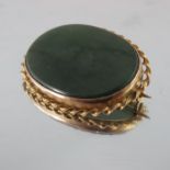 A Victorian gold mounted jade brooch