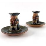 Harry Simeon for Doulton Lambeth, a pair of stoneware figural candlesticks