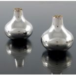 Stuart Devlin, a pair of Modernist silver and parcel gilt salt and pepper pots, London 1976