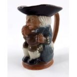 Harry Simeon for Doulton Lambeth, a miniature jug modelled as a seated Toby,