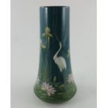 Jerome Massier, a vase decorated with a stork by the side of a pool with irises and waterlilies,