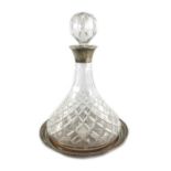 An Elizabeth II silver mounted cut glass ships decanter and wine coaster