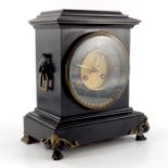 A late 19th Century black slate mantel clock with cicular gilded dial