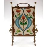 An Arts and Crafts brass and beadwork fire screen