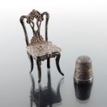 An Elizabeth II silver miniature chair and an Edwardian silver thimble