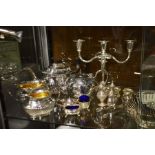 A silver plated three piece tea set, a three branc