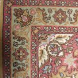 A Persian rug, floral medallion to a mustard groun