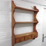 A set of pine wall hanging shelves fitted three sm