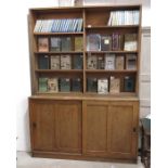 An oak bookcase fitted adjustable shelves above tw