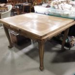 An oak French style extending dining table, carved