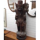 An Indonesian carved wooden figure, carved and sta