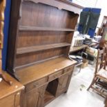 An oak dresser, shelf back over two drawers and ce