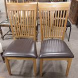 A pair of oak comb back dining chairs, stuffover b