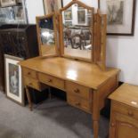 A pine kneehole dressing table, three fold mirror