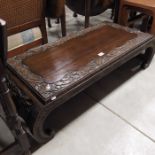 A carved Chinese scroll end coffee table, 122cm wi