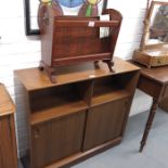 A 1970's bookcase, shelves above two sliding doors,