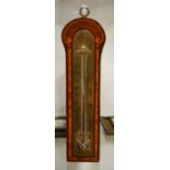 A wall thermometer, brass engraved plate on a marq