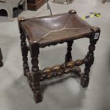 A leather topped oak joint stool with bobbin turne