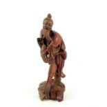 A Chinese carved wood figure of a fisherman