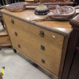 An Edwardian oak chest of three graduated drawers,