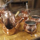 A wooden handled copper chocolate pot; two copper