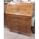 A Walnut bureau, fitted three graduated drawers, o