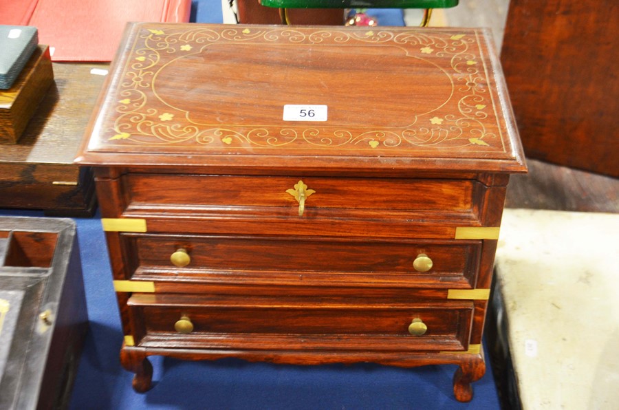 An Indonesian hardwood brass inlaid vanity chest w