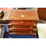 An Indonesian hardwood brass inlaid vanity chest w