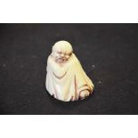 Resin figure of a resting man, height 5cm.