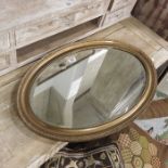 An oval gilt framed wall mirror.75cm wide.