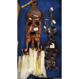 Two carved wooden tribal masks and a carved wooden