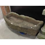 A carved stone bow front garden trough.