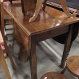 A George III drop leaf dining table, on chamfered