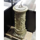 A cast brass sundial on cast stone column with fru