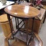 An oak oval hall table on bobbin turned supports u