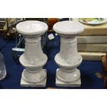 A pair of terracotta white glazed baluster form pe