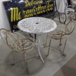 A pair of French style patio chairs, scrolled meta