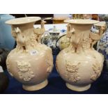 A pair of cream glazed baluster form earthenware v