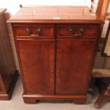 A modern yew wood cabinet fitted two drawers above