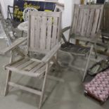 A pair of oak folding garden armchairs. (2)