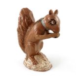 An Astbury type 18th Century Staffordshire pottery figure of a squirrel