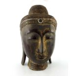 An Oriental carved and gilt wood bust of Buddha